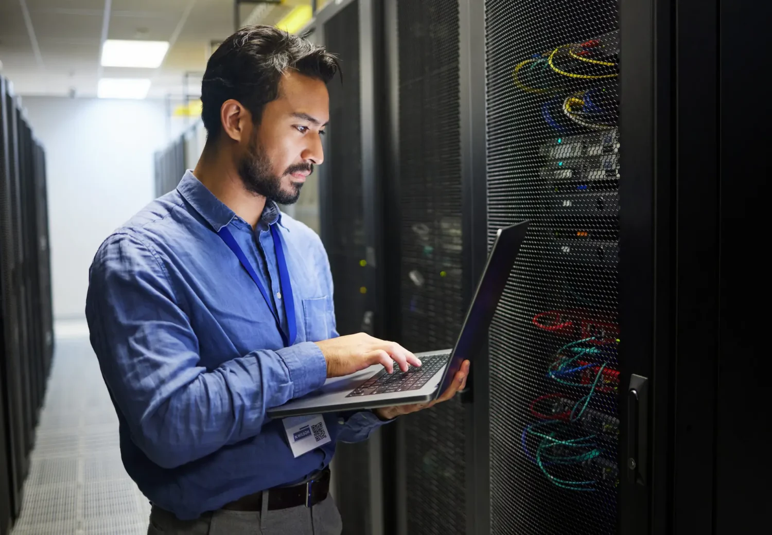 IT Worker running diagnostics in server room