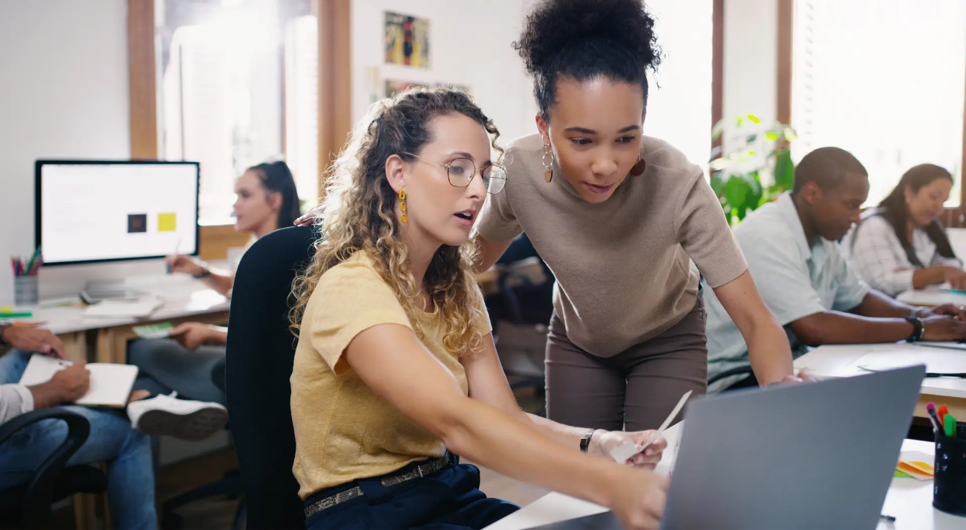 Two women collaborating on IT Consulting project