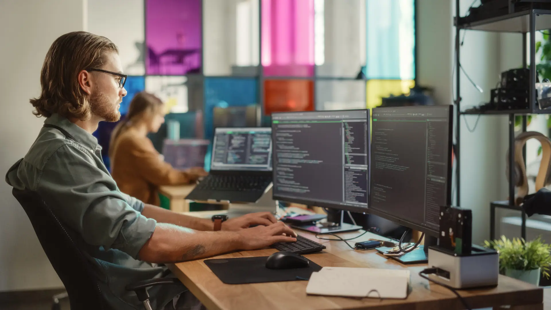 IT Worker reviewing code at desk
